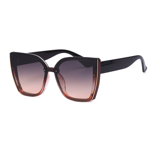 Women's black cat-eye sunglasses with large frames, gradient gray lenses, and gold-tone accents. - Image 2
