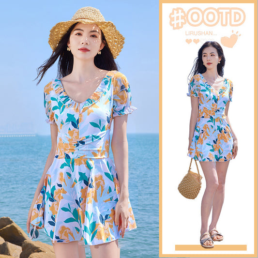 White floral high waist swimsuit dress with orange, teal, and navy flowers, ruffled scoop neck, and puff sleeves. - Image 2