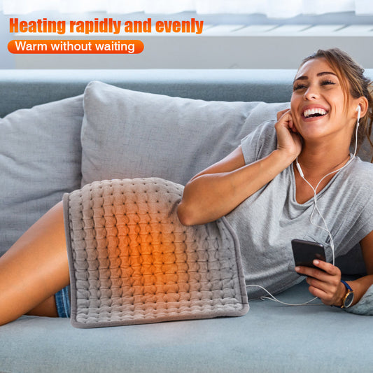 Gray quilted electric heating pad with a white wired controller and power plug, partially rolled up. - Image 2