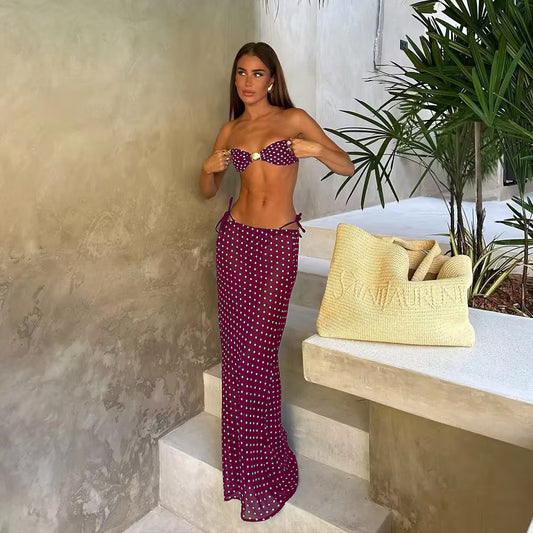 Woman in a navy blue polka dot tube top bikini and matching maxi skirt with side ties, posing outdoors. - Image 2