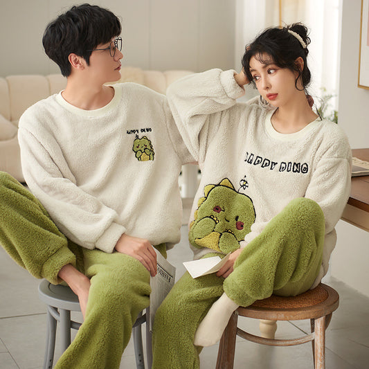 Couple wearing matching cream coral fleece pajamas with gray pants and bear embroidery, seated on a bed. - Image 2