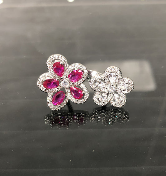 Silver-tone ring with two flower designs, one with crimson gemstones and clear zircons, the other with clear zircons. - Image 2