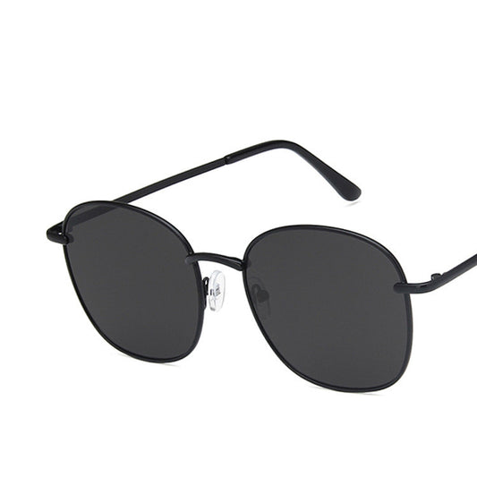 Gold metal round sunglasses with dark gray resin lenses and black temple tips on a white background. - Image 2