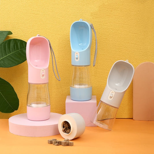 Pink portable pet water bottle with integrated feeder bowl, clear reservoir, and dispensing button for dogs. - Image 2