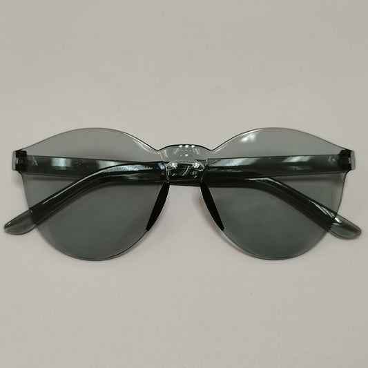 Trendy one-piece candy-colored sunglasses with dark gray lenses and a unique wavy top edge.