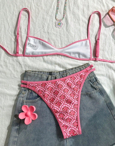 Pink two-piece bikini with a red floral and geometric print, featuring a bandeau top and high-cut bottoms. - Image 3