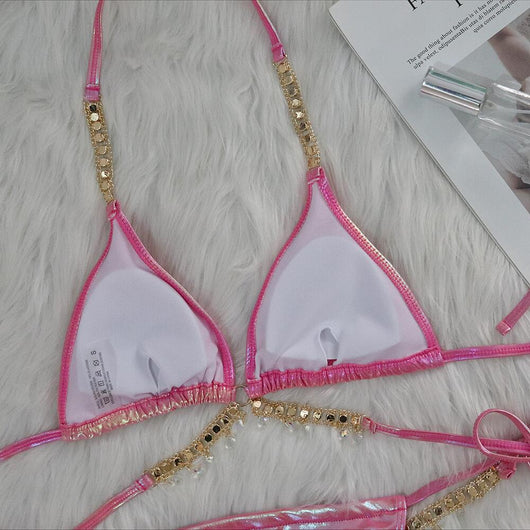 Iridescent purple and pink two-piece bikini with gold-toned crystal embellishments on a white faux fur background. - Image 13