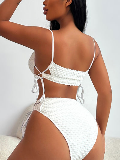 Creamy-white textured two-piece swimsuit with a bandeau top and high-waisted bottoms featuring side ties and cut-outs. - Image 4