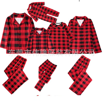 Baby in a red and black buffalo plaid long-sleeve pajama romper, viewed from the back with arms raised. - Image 6
