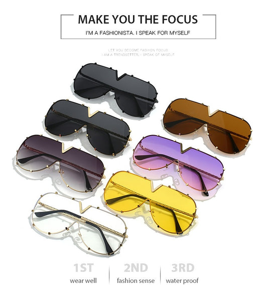 Oversized V-shaped sunglasses with a gold metal frame, white accents, clear lenses, and decorative rivets. - Image 15