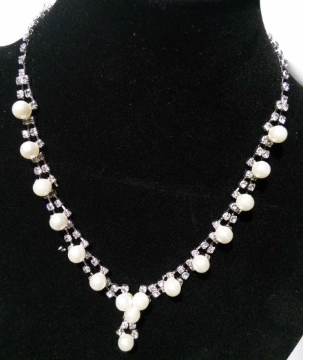 Silver-tone bridal jewelry set with a pearl and rhinestone necklace and matching dangle earrings. - Image 5