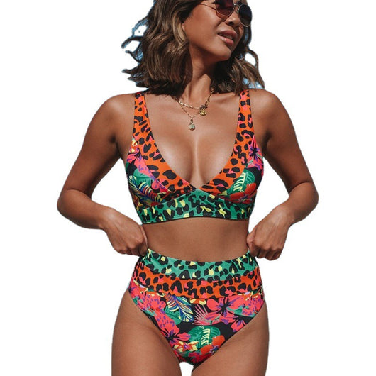 Women's high-waisted bikini with a vibrant floral and leopard print in blue, orange, and green, at the beach. - Image 6