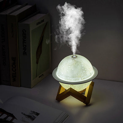 White moon-shaped humidifier with a textured surface resembling craters and a thin ring around its middle. - Image 8
