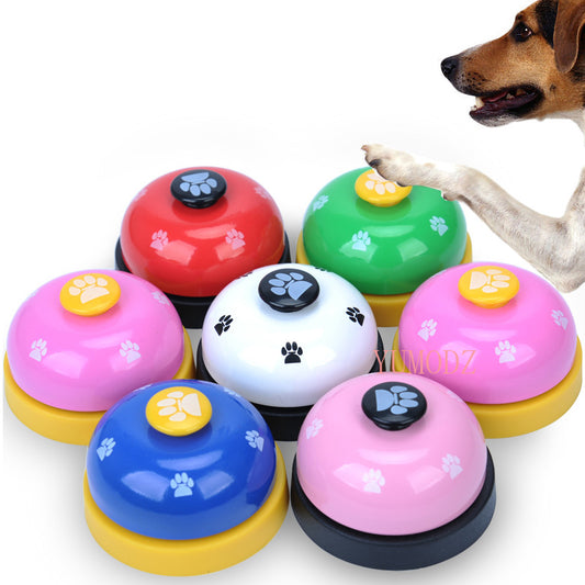 Blue and yellow pet training bell with white paw print designs and a large yellow button on top.