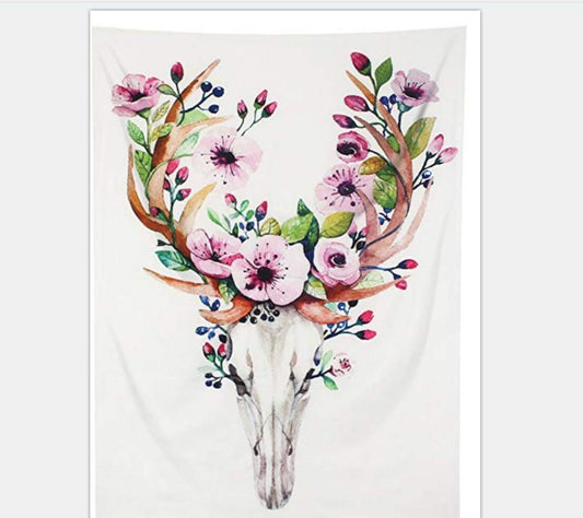 White tapestry with a watercolor deer skull and antlers adorned with pink flowers, green leaves, and blue berries.