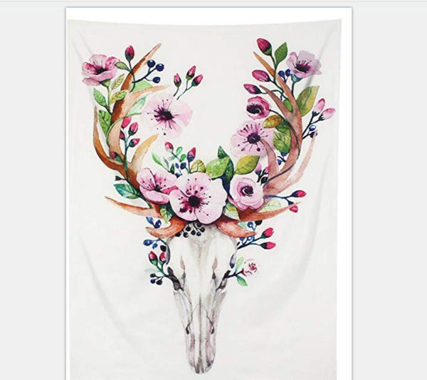 White tapestry with a watercolor deer skull and antlers adorned with pink flowers, green leaves, and blue berries.