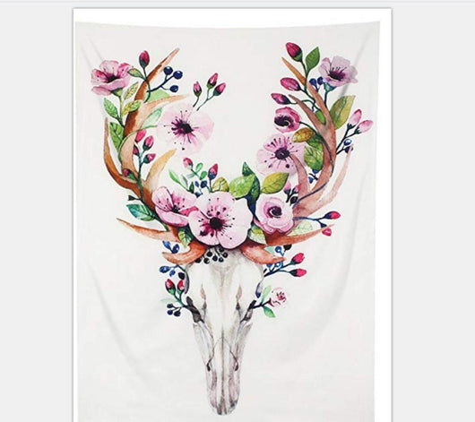 White tapestry with a watercolor deer skull and antlers adorned with pink flowers, green leaves, and blue berries.