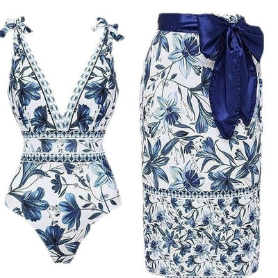 Women's white one-piece swimsuit with deep V-neck, blue floral and geometric patterns, and tie-shoulder straps. - Image 6