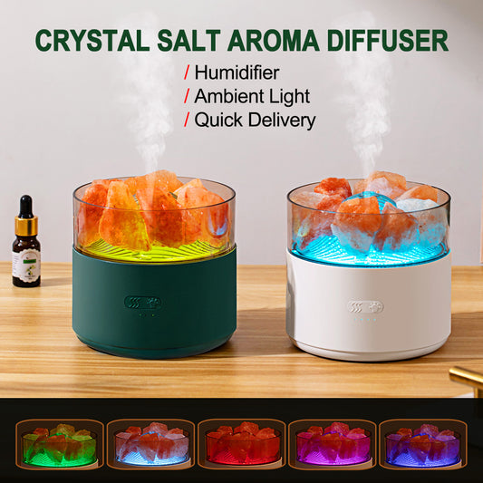 White cool-mist humidifier and aroma diffuser with glowing blue LED lights and orange crystal salt rocks, emitting mist.