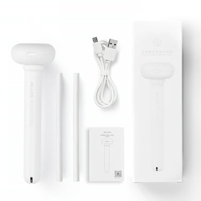 Clear bottle-shaped USB humidifier with a white donut-style top, emitting a stream of cool mist on a wooden table. - Image 2