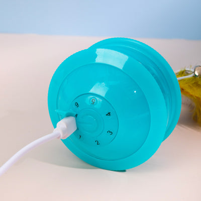 Teal cat toy with a feather and bell attachment, held in a hand against a blue and beige background. - Image 4