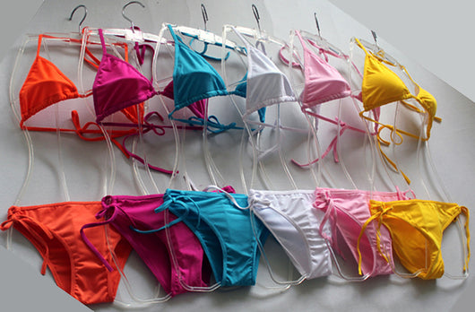 Solid pink two-piece bikini set featuring a triangle top and tie-side bottoms, modeled by a woman by a pool. - Image 26