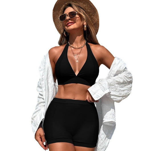 Woman in a hot pink halter neck bikini top and matching high-waisted swim shorts at the beach. - Image 5