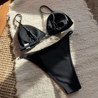 Woman wearing a black sequined triangle bikini top and high-cut bottom on a sunny beach. - Image 19
