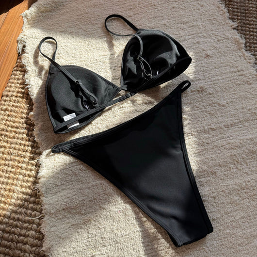 Woman wearing a black sequined triangle bikini top and high-cut bottom on a sunny beach. - Image 19