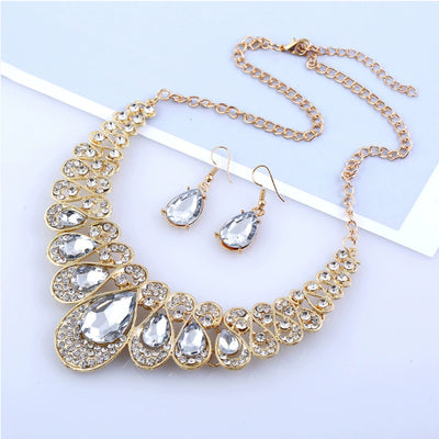 Gold-tone necklace and matching drop earrings set with clear teardrop gems and sparkling rhinestones. - Image 9