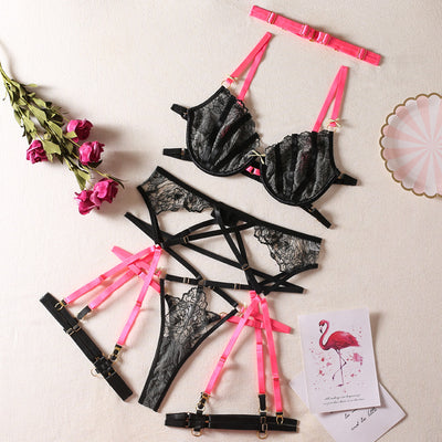Black lace bra and thong set with hot pink harness straps, gold-tone rings, and a matching hot pink choker. - Image 6