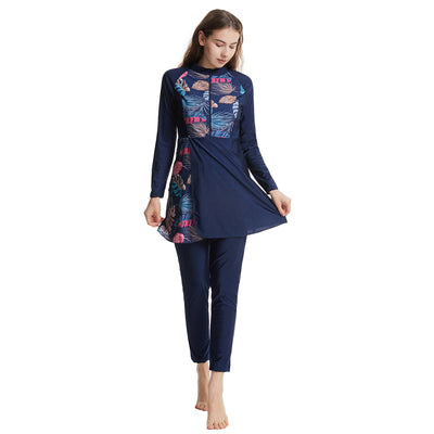 Woman in a navy blue quick-drying conservative swimwear set with a tropical leaf print tunic and matching swim cap. - Image 26