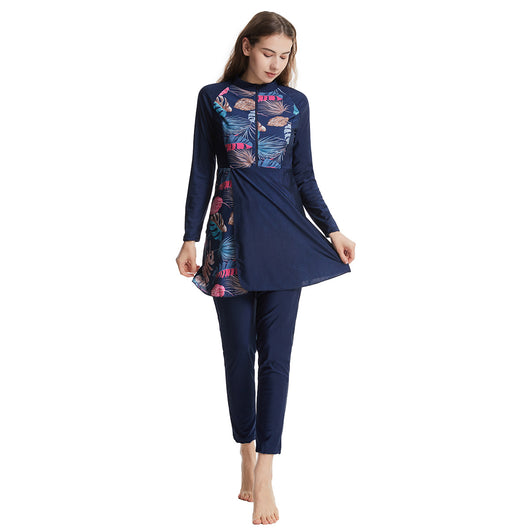 Woman in a navy blue quick-drying conservative swimwear set with a tropical leaf print tunic and matching swim cap. - Image 26