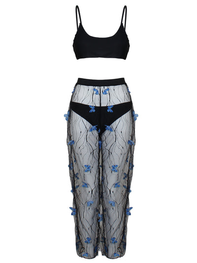 Women's black bikini three-piece set with a spaghetti strap top, matching bottoms, and sheer voile pants with blue butterfly appliques. - Image 6