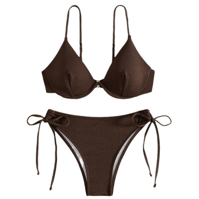 Black ribbed two-piece bikini with an underwire top and tie-side bottoms on a white marble surface. - Image 5