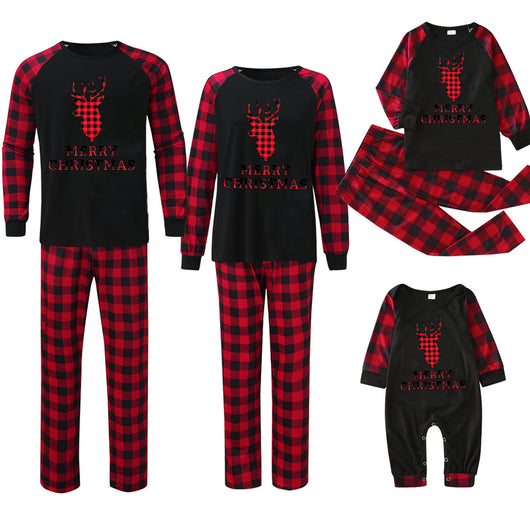 Family matching Christmas pajamas with black tops featuring a wine glass in a Santa hat graphic and red plaid bottoms. - Image 3