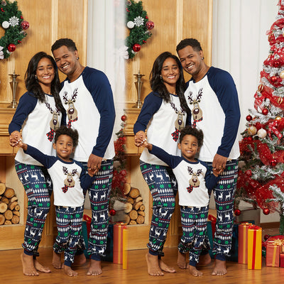 Family of three wearing matching Christmas pajamas with reindeer tops and snowflake-patterned pants. - Image 3