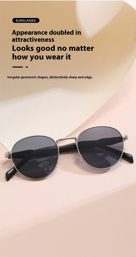 Silver metal round frame sunglasses with dark grey lenses and black temples, offering UV protection for women. - Image 19