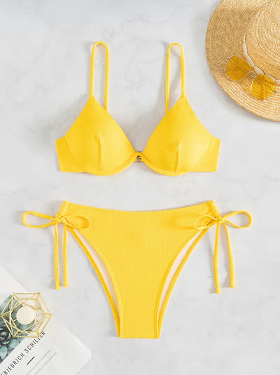 Black ribbed two-piece bikini with an underwire top and tie-side bottoms on a white marble surface. - Image 28