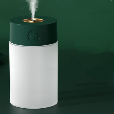 White cylindrical humidifier with a gold nozzle emitting mist, featuring a subtle bear emblem. Includes five aromatherapy oil bottles. - Image 6