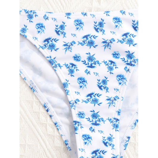 Woman smiling in a white bikini with blue floral print, triangle top, and briefs bottoms, on a sunny beach. - Image 41