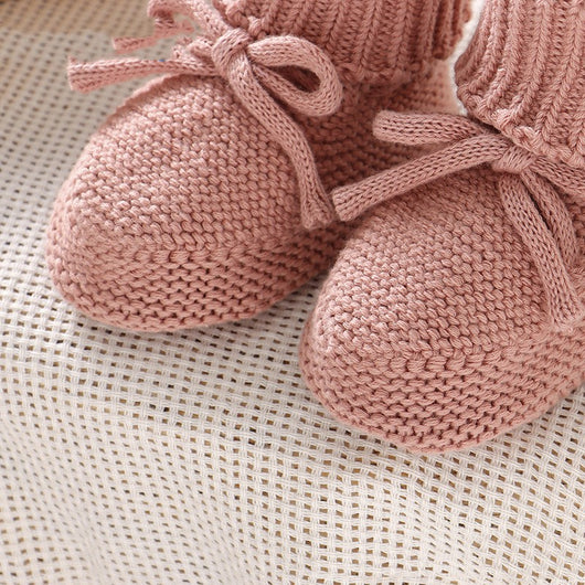 Pink knitted infant toddler shoes with cute bowknots and elastic bands, displayed on a soft white rug. - Image 12