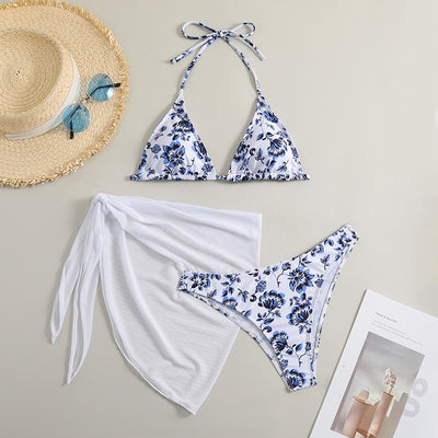 White and yellow floral print three-piece bikini set with a halter triangle top, high-cut bottom, and sheer white sarong. - Image 9