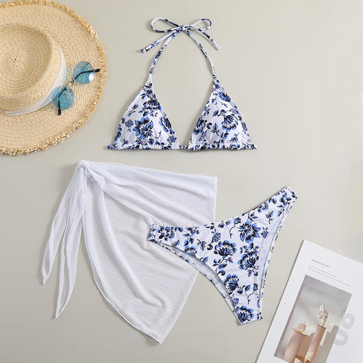 White and yellow floral print three-piece bikini set with a halter triangle top, high-cut bottom, and sheer white sarong. - Image 9