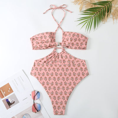 Dark green floral one-piece swimsuit with halter neck, bandeau top, cut-outs, and matching sheer sarong.