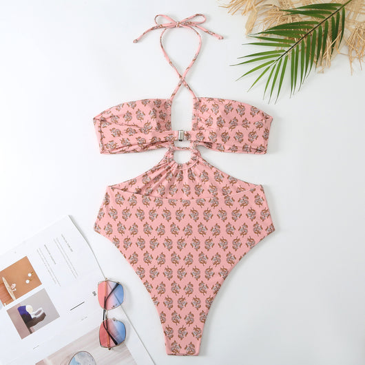Dark green floral one-piece swimsuit with halter neck, bandeau top, cut-outs, and matching sheer sarong.