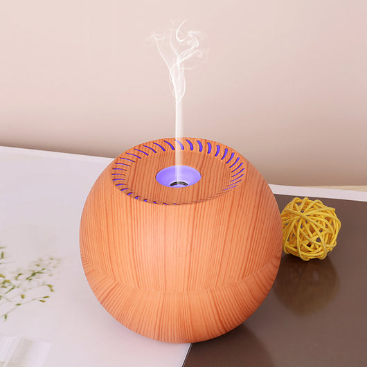 Dark wood grain spherical USB humidifier with a green light and mist emitting from the top, featuring a power button icon. - Image 3