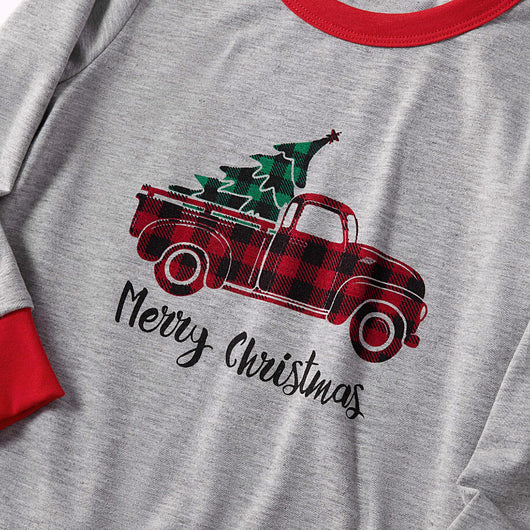 Family of four wearing matching gray long-sleeve pajamas with red truck and Christmas tree graphic, red and black plaid pants. - Image 12