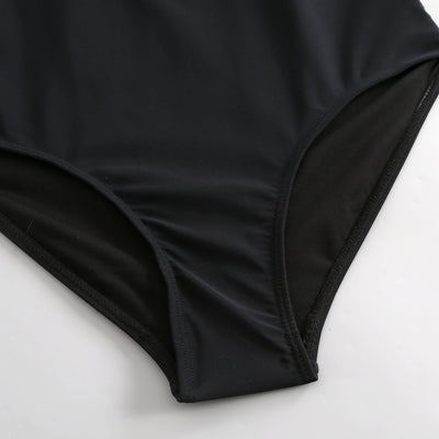 Black one-piece swimsuit with a deep V-neckline and white horizontal stitching detail across the plunge. - Image 22