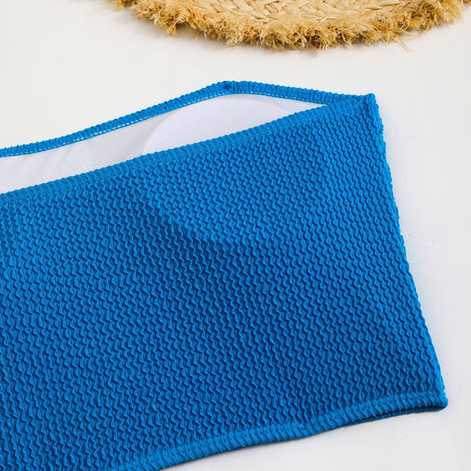Blue high-waisted bikini set with a textured bandeau top and high-cut bottoms, laid flat on white. - Image 22